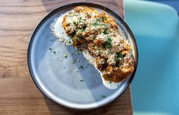 Spicy harissa and cool, rich tahini top crispy cauliflower at Bey Mediterranean Kitchen & Bar in Roswell. (Courtesy of Bey Mediterranean Kitchen & Bar)