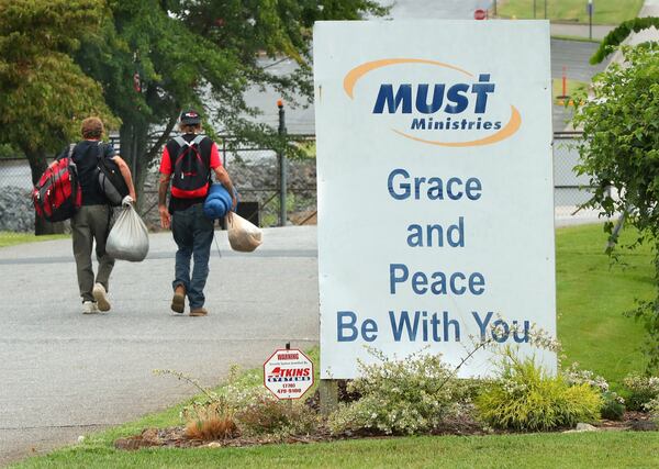 A pair of homeless men head out for the day after getting some assistance at MUST Ministries on Wednesday, August 9, 2017, in Marietta. Neighbors are fighting an expansion of Marietta's largest homeless shelter, but the shelter's directors say they are meeting a need amidst growing suburban poverty and homelessness.   Curtis Compton/ccompton@ajc.com