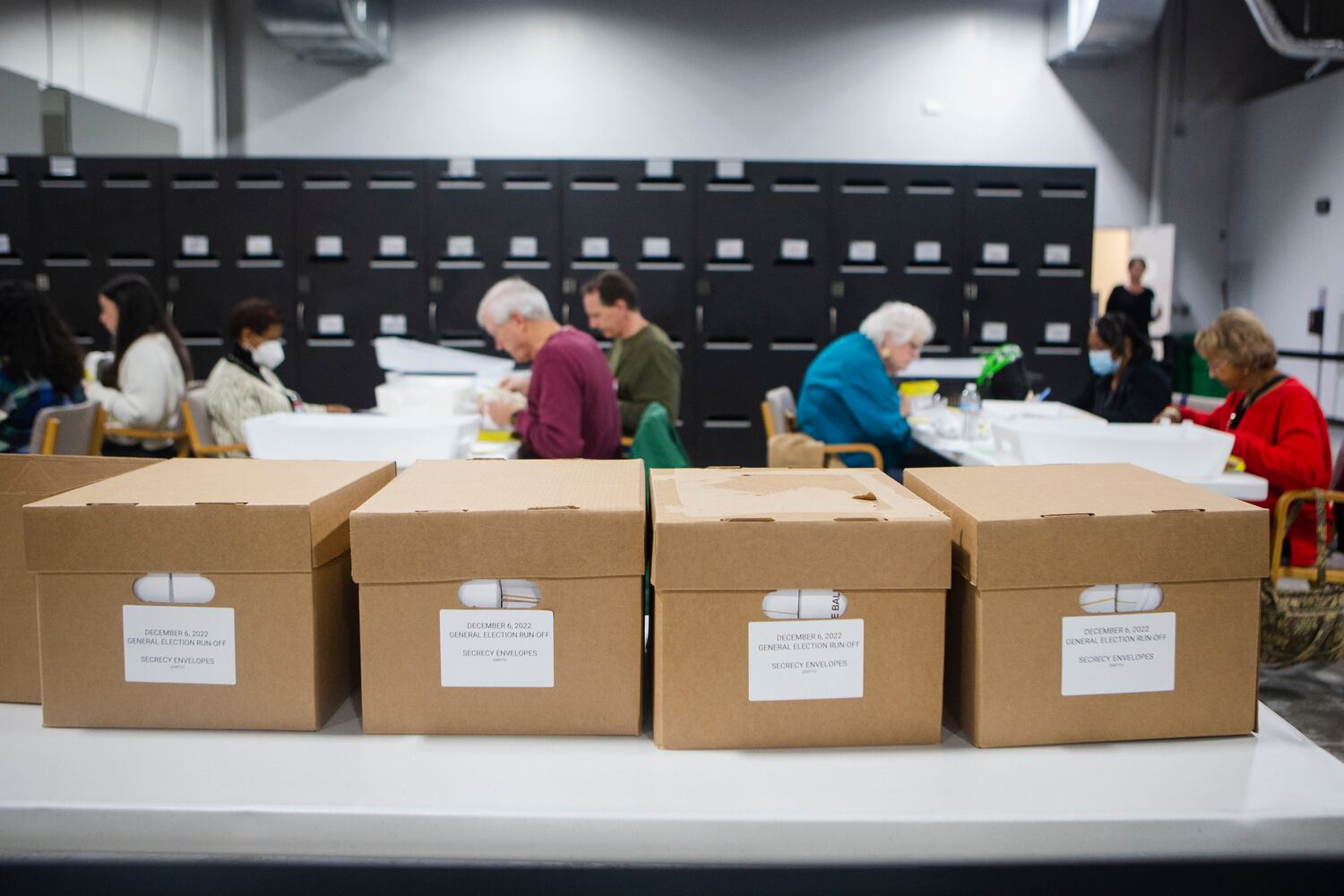 Workers at the Gwinnett County Voter Registrations and Elections headquarters count votes delivered by poll managers in the Senate runoff election on Tuesday, December 6, 2022, in Lawrenceville, Georgia. Candidates incumbent Raphael Warnock and Herschel Walker faced off for the seat.  CHRISTINA MATACOTTA FOR THE ATLANTA JOURNAL-CONSTITUTION.