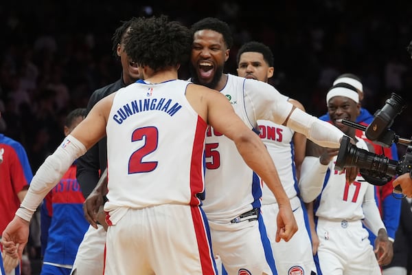 Detroit Pistons guard Cade Cunningham (2) is cheered by his teammates after scoring the winning basket during the second half of an NBA basketball game against the Miami Heat, Wednesday, March 19, 2025, in Miami. (AP Photo/Marta Lavandier)