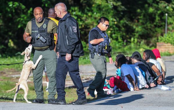 Morrow police took 12 people into custody during a raid Wednesday at a home in the 5000 block of Jonesboro Road.