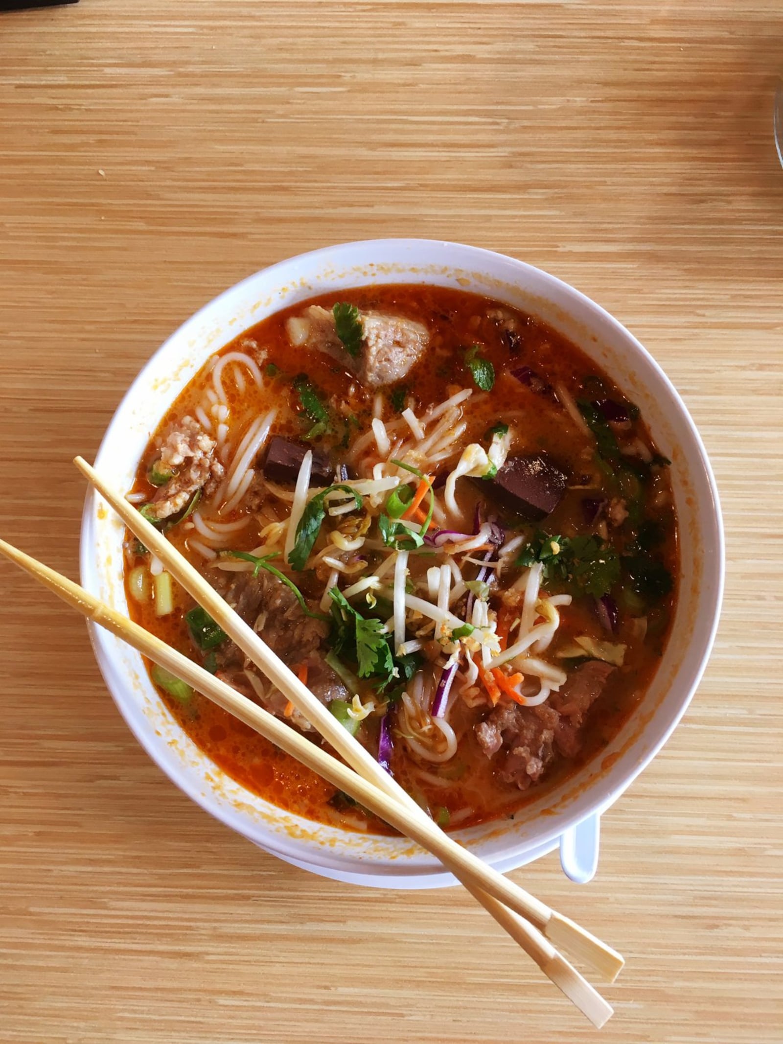 A bowl of khao poon at Snackboxe Bistro is rich and laden with red curry. CONTRIBUTED BY WYATT WILLIAMS