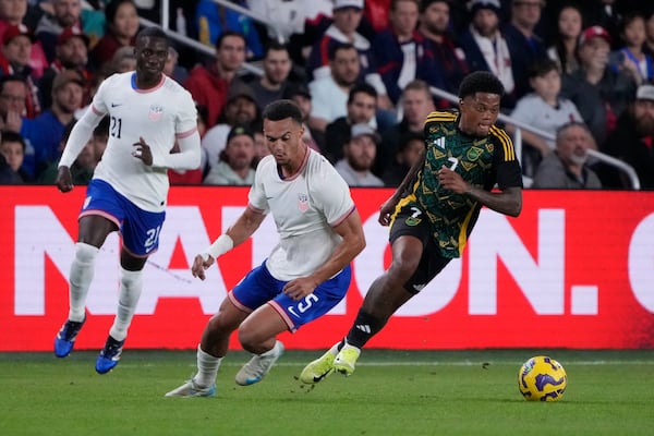 Jamaica's Leon Bailey, right, chases after a loose ball as United States' Antonee Robinson (5) and Tim Weah (21) defend during the first half in a CONCACAF Nations League quarterfinal second leg soccer match Monday, Nov. 18, 2024, in St. Louis. (AP Photo/Jeff Roberson)