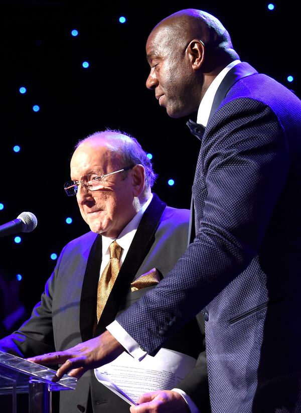 onstage at the Pre-GRAMMY Gala and Salute To Industry Icons honoring Martin Bandier at The Beverly Hilton Hotel on February 7, 2015 in Beverly Hills, California. Magic Johnson introduces Clive Davis. Photo: Getty Images.