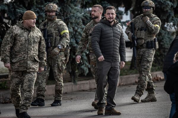 Ukrainian President Volodymyr Zelenskyy, center, is meeting with President Biden today and may address Congress. He is pictured in the main square of Kherson, Ukraine, on Nov. 14, 2022. (Finbarr O'Reilly/The New York Times)