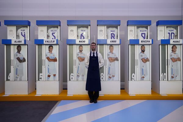 The Real Madrid first-team changing room lockers from Santiago Bernabeu Stadium are displayed at Sotheby's auction rooms in London, Wednesday, Nov. 20, 2024. The sale features 24 individual lockers previously used by footballers including Cristiano Ronaldo, David Beckham and Zinedine Zidane. (AP Photo/Kin Cheung)