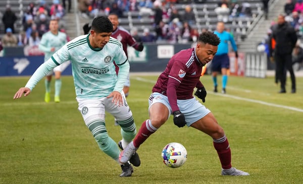 Atlanta United's Alan Franco, left, vies for control of the ball with Colorado Rapids' Jonathan Lewis during the first half of an MLS soccer match Saturday, March 5, 2022, in Commerce City, Colo. (AP Photo/David Zalubowski)