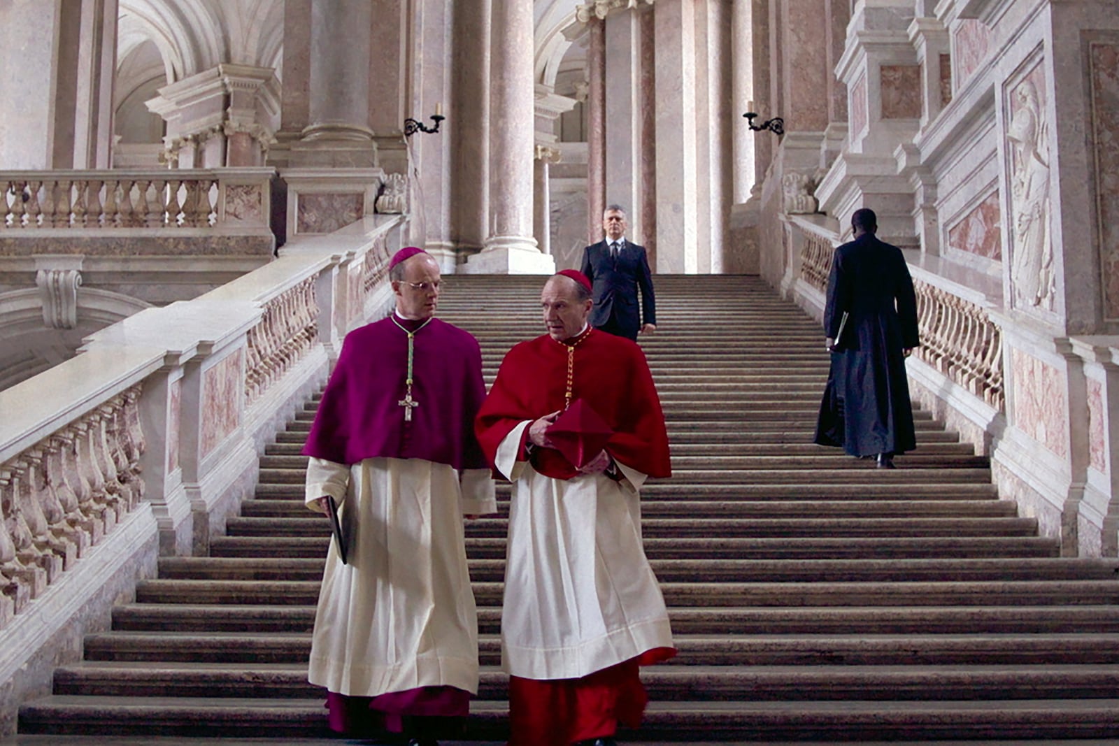 This image released by Focus Features shows Brían F. O'Byrne, left, and Ralph Fiennes in a scene from "Conclave." (Focus Features via AP)