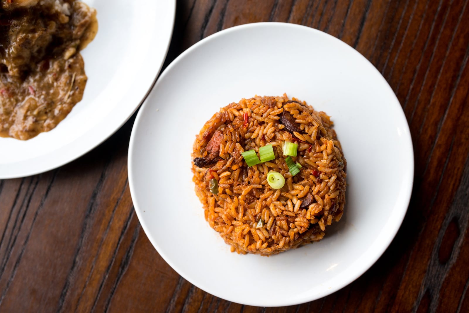 The red rice at Virgil’s, which is long-grain white rice cooked in tomato sauce with onions and peppers, also has bacon and smoked sausage. CONTRIBUTED BY MIA YAKEL