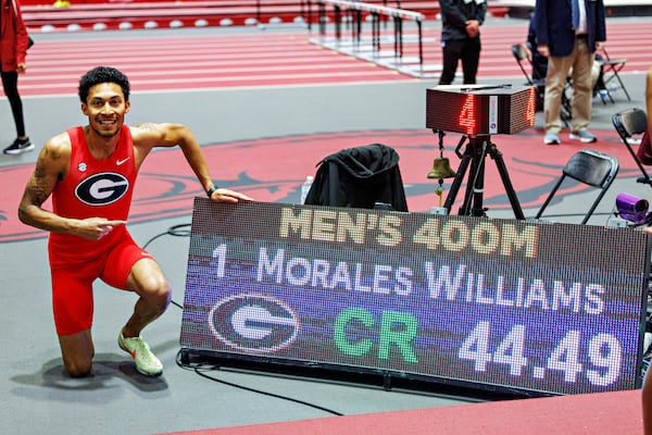 Georgia sophomore Christopher Morales Williams poses next to the scoreboard that recorded his world's-best 400-meter time of 44.79 seconds, which he ran Saturday, Feb. 24, 2024 at the SEC Indoor Track & Field Championships in Fayetteville, Arkansas. (Photo from UGA Athletics)