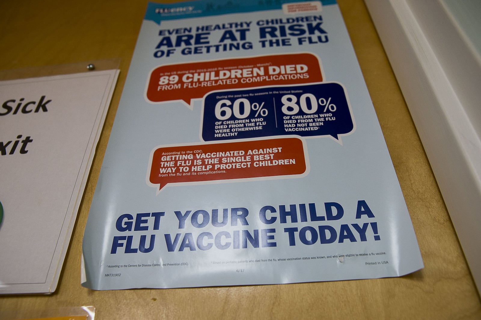 An Influenza Vaccine poster is displayed at Conyers Pediatrics in Conyers. (Alyssa Pointer/Atlanta Journal Constitution)