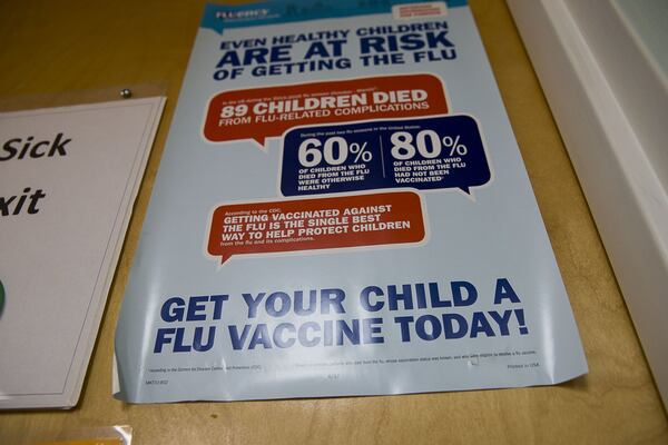 An Influenza Vaccine poster is displayed at Conyers Pediatrics in Conyers. (Alyssa Pointer/Atlanta Journal Constitution)