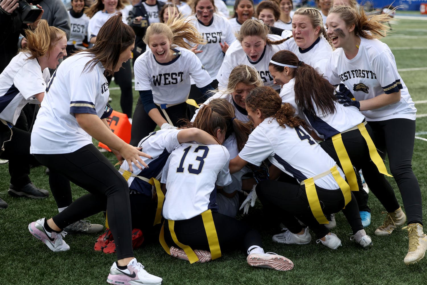 West Forsyth quarterback Haylee Dornan is smothered by teammates after she scored the game-winning extra point in a 26-25 2-OT win against Hillgrove. JASON GETZ FOR THE ATLANTA JOURNAL-CONSTITUTION