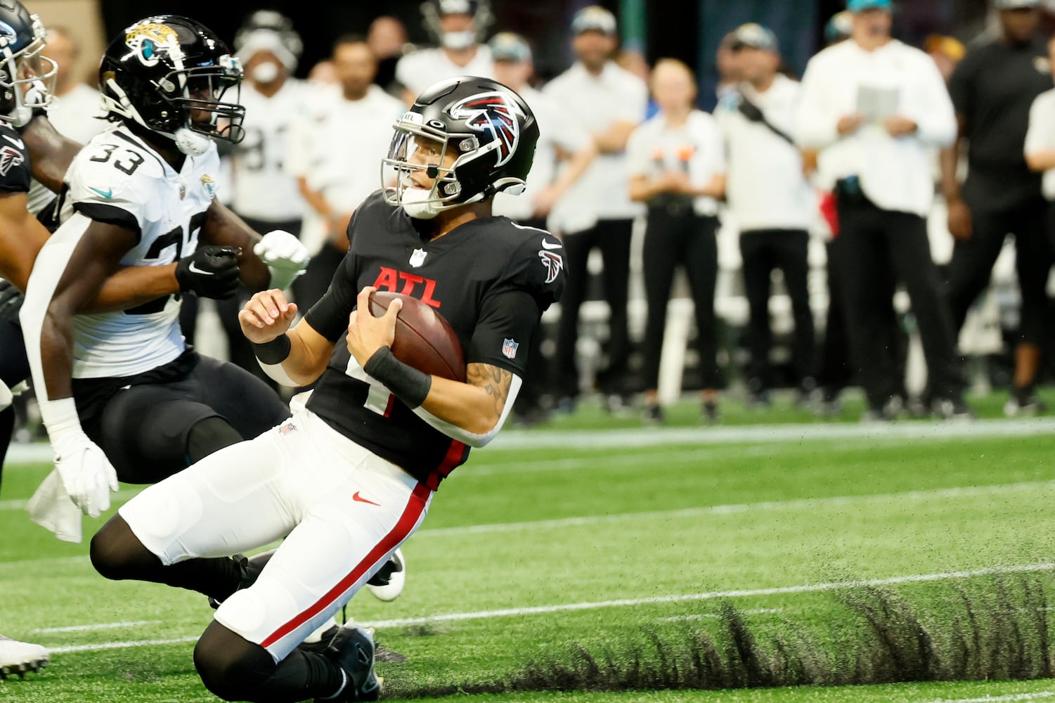 Atlanta Falcons' quarterback Desmond Ridder (4) slides after a rush during the first half of an NFL exhibition game against the Jacksonville, Jaguars on Saturday, August 27, 2022, at the Mercedes-Benz Stadium in Atlanta, Ga.
 Miguel Martinez / miguel.martinezjimenez@ajc.com