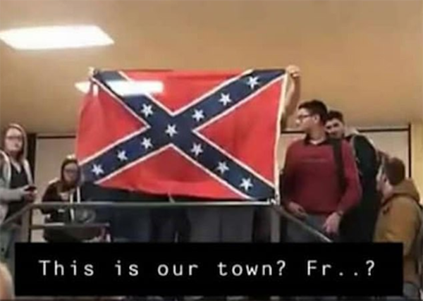 Students at West Plains High School in Missouri are shown holding up a Civil War Confederate battle flag last week in response to classmates handing out rainbow flags.