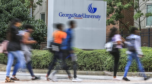 Georgia State University students cross Ellis Street at Piedmont Avenue on Monday, Aug. 20, 2018. The university has nearly more low-income students than any university in the nation. University officials believe they’ve had success helping low-income students by offering retention grants to students to help with tuition in recent years. Eighty-six percent of those students have graduated, the university says.