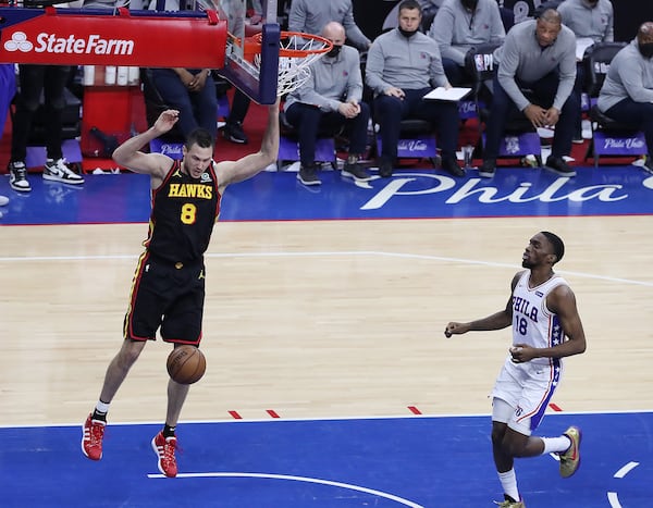 Hawks forward Danilo Gallinari dunks ahead of Philadelphia 76ers guard Shake Milton on a breakaway after forcing a turnover to give Atlanta a 98-92 lead with 41 seconds remaining in Game 7 of the Eastern Conference semifinals Sunday, June 20, 2021, in Philadelphia. (Curtis Compton / Curtis.Compton@ajc.com)