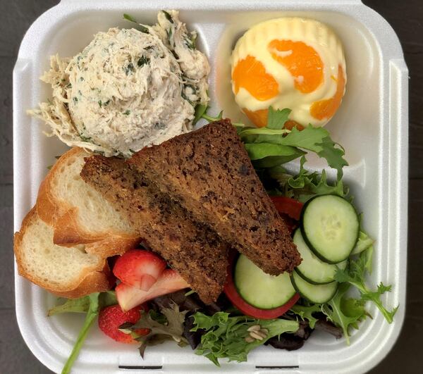 Cafe Lapin’s mandarin orange souffle with a scoop of tarragon chicken salad. The plate comes with banana bread, sliced baguette and green salad. CONTRIBUTED BY WENDELL BROCK