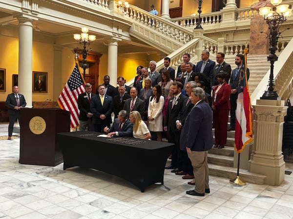 Gov. Brian Kemp signs a new package of human trafficking measures Wednesday at the Georgia Capitol. Contributed. 