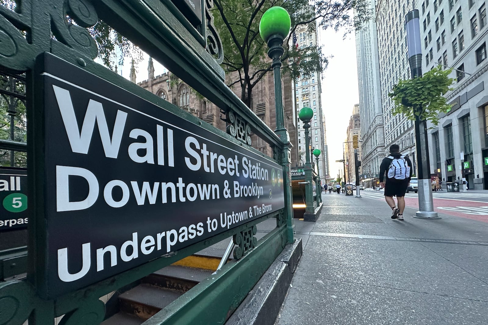 FILE - People pass the entrance for the Wall Street subway station on Sept. 2, 2024, in New York. (AP Photo/Peter Morgan, File)