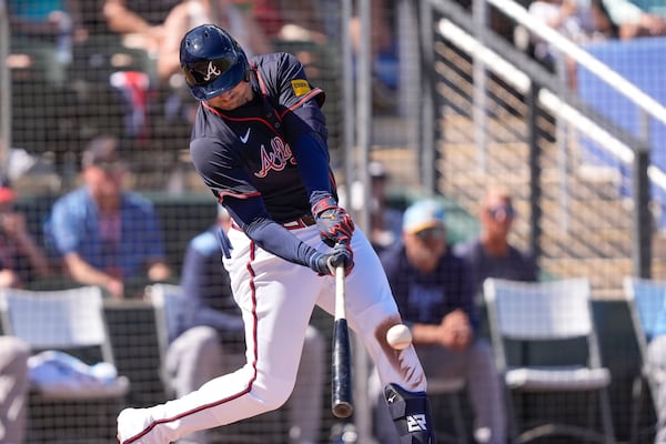 Atlanta Braves Austin Riley lines out to advance a runner to third base in the third inning of a spring training baseball game against the Tampa Bay Rays in North Port, Fla., Sunday, Feb. 23, 2025. (AP Photo/Gerald Herbert)