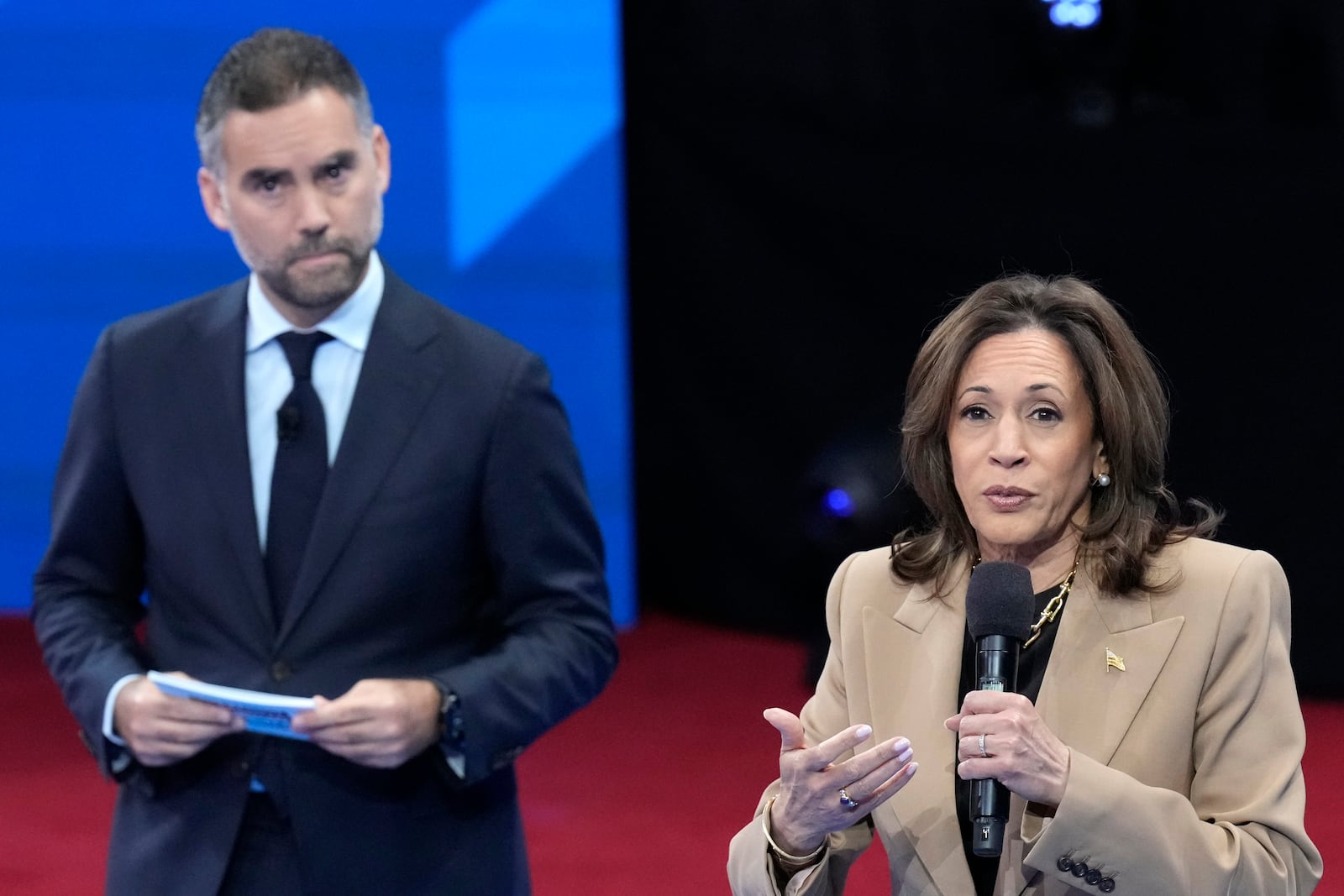 Democratic presidential nominee Vice President Kamala Harris speaks as moderator Enrique Acevedo listens during a Town Hall event hosted by Univision, Thursday, Oct. 10, 2024, at the University of Nevada Las Vegas. (AP Photo/Jacquelyn Martin)