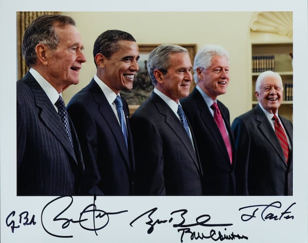 A signed photograph of five U.S. presidents — George H.W. Bush, Barack Obama, George W. Bush, Bill Clinton,  and  Jimmy Carter — will be among the items Carter will be auctioning off this week to raise funds to support The Carter Center. Another photo, signed by Carter, George H.W. Bush, Gerald Ford, Ronald Reagan and Richard Nixon, will also be up for auction. (Carter Center)