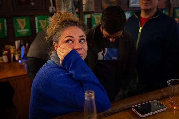 Alba Cristancho becomes emotional while watching CNN on election night at Manuel’s Tavern in Atlanta on Tuesday, November 5, 2024. Republican presidential candidate Donald Trump won Georgia, according to a call by CNN. (Arvin Temkar / AJC)