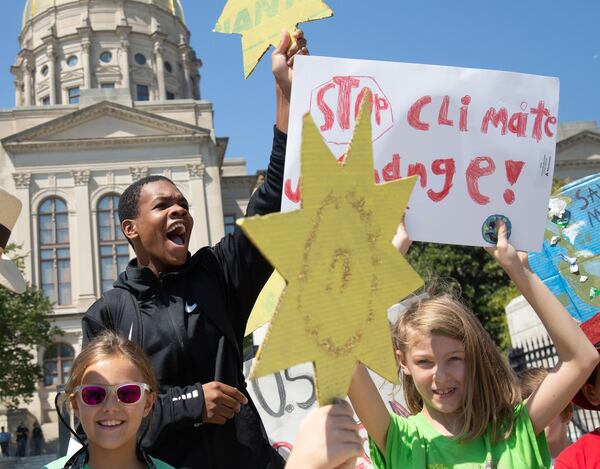 Jordan Madden (L) from Moutzion High School cheers near the Georgia Capitol during the Climate Reality Strike March Friday, September 20, 2019.  