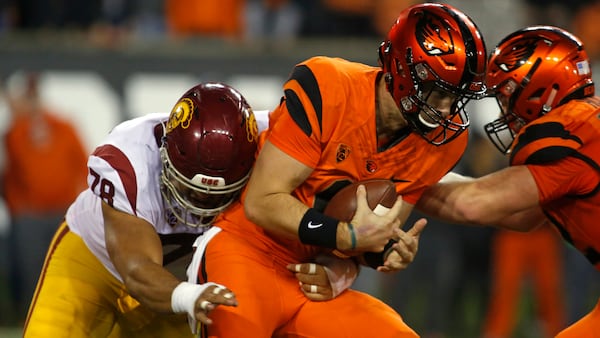 Oregon State quarterback Jake Luton (center) is sacked by Southern California's Jay Tufele (left) in the second half in Corvallis, Ore., on Saturday, Nov. 3, 2018. Southern California won 38-21. (Timothy J. Gonzalez/AP)