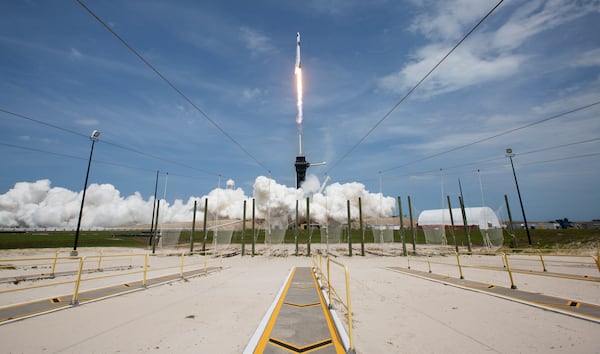 In this photo provided by NASA, a SpaceX Falcon 9 rocket carrying the company's Crew Dragon spacecraft is launched from Launch Complex 39A.