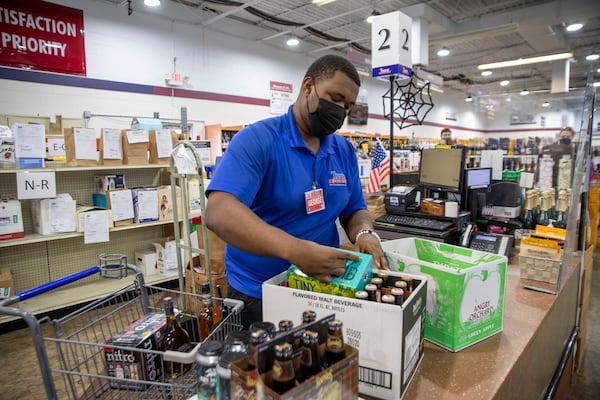 10/22/2020 - Atlanta, Georgia - Tower Beer, Wine & Spirits  manager George Shelley fills a customerÕs delivery order at the store in AtlantaÕs Lindbergh/Morosgo neighborhood, Thursday, October 22, 2020.  (Alyssa Pointer / Alyssa.Pointer@ajc.com)