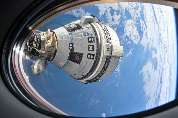 FILE - This photo provided by NASA shows Boeing's Starliner spacecraft, which launched astronauts Butch Wilmore and Suni Williams to the International Space Station, docked to the Harmony module's forward port on July 3, 2024, seen from a window on the SpaceX Dragon Endeavour spacecraft docked to the adjacent port. (NASA via AP, File)