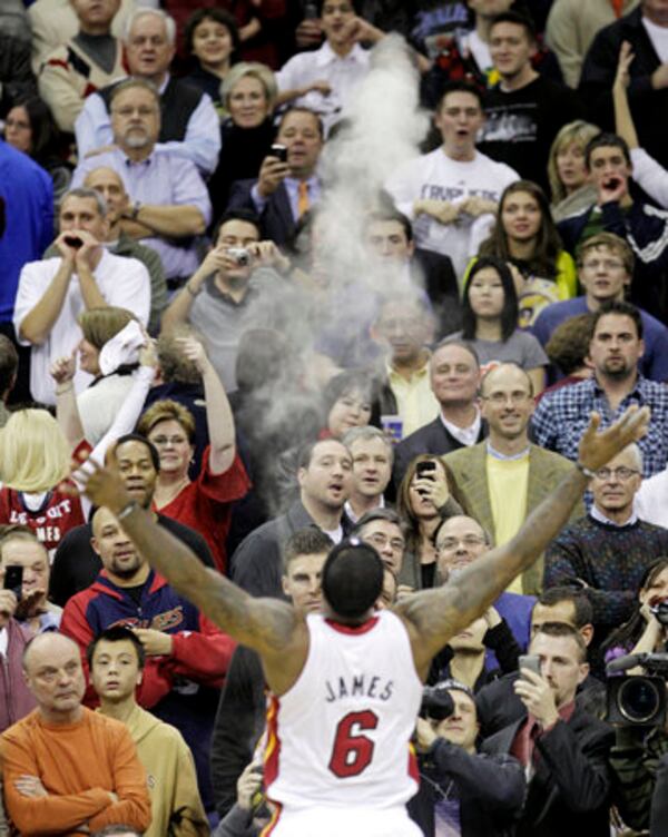 Cleveland fans watch Miami Heat forward LeBron James (6) go through his pregame ritual before an NBA basketball game against the Cleveland Cavaliers, Thursday, Dec. 2, 2010, in Cleveland. (AP Photo/Tony Dejak) Gone from South Beach in a puff of smoke. (AP photo)