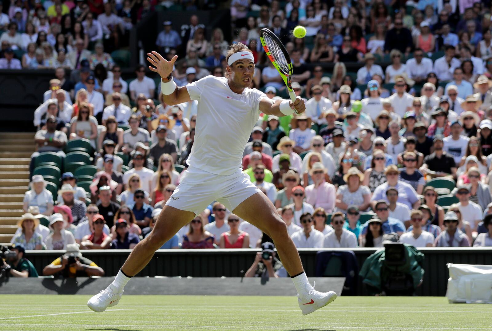 FILE - Rafael Nadal, of Spain, returns the ball to Dudi Sela, of Israel, during their men's singles match, on the second day of the Wimbledon Tennis Championships in London, Tuesday July 3, 2018. (AP Photo/Ben Curtis, File)