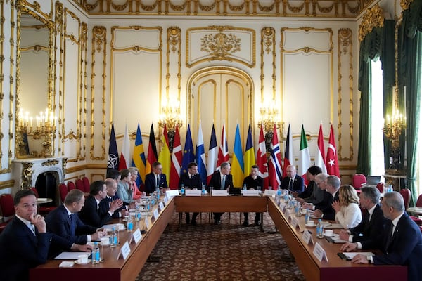 Britain's Prime Minister Keir Starmer, center, French President Emmanuel Macron, center left, and Ukraine's President Volodymyr Zelenskyy, center right, attend a meeting with European leaders during a summit on Ukraine at Lancaster House in London, Sunday, March 2, 2025. (AP Photo/Christophe Ena, Pool)