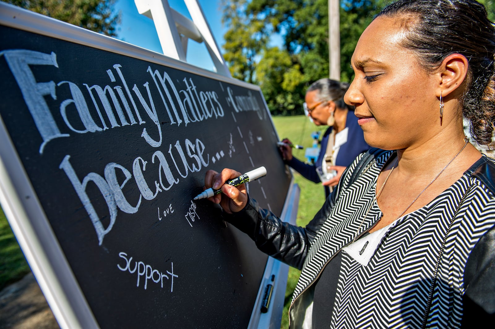 Nasim Fluker (right) and Robyn Sims fill in why family and community matter to them before the start of the Families First groundbreaking ceremony at the historic E.R. Carter Elementary School in Atlanta on Thursday, September 17, 2015. The school will become the new site of the Families First Resource Center. Families First is celebrating 125 years of helping Georgia families become self sufficient in a safe, stable and nurturing environement. JONATHAN PHILLIPS / SPECIAL