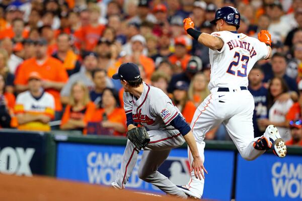 11/2/21 - Houston, Tx. - Atlanta Braves starting pitcher Max Fried has his ankle stepped on by Houston Astros left fielder Michael Brantley (23) as Fried fielded first base during the first inning in game 6 of the World Series at Minute Maid Park, Tuesday, November 2, 2021, in Houston, Tx. Curtis Compton / curtis.compton@ajc.com