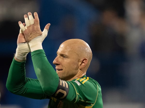 Atlanta United goalkeeper Brad Guzan (1) celebrates a penalty shootout win over CF Montreal following an MLS soccer wild-card playoff game in Montreal, Tuesday, Oct. 22, 2024. (Christinne Muschi/The Canadian Press via AP)