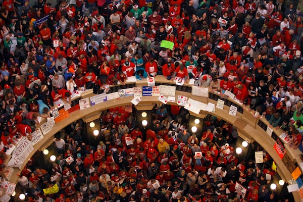 FILE - This file photo taken Feb. 17, 2011 shows protestors of Wisconsin Gov. Scott Walker's bill to eliminate collective bargaining rights for many state workers packing the rotunda at the State Capitol in Madison, Wis. (AP Photo/Andy Manis, File)