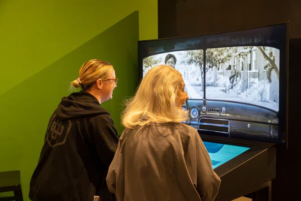 Curators at the Jimmy Carter Presidential Library and Museum in Atlanta, test a new exhibit that is part of "The Negro Motorist Green Book," exhibit which opens Saturday, March 30, 2024. (Olivia Bowdoin for the AJC).