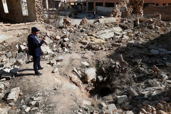 FILE - Syrian-American Henry Hamra takes pictures at a synagogue destroyed during the war at the Jobar district in the outskirts of Damascus, Feb. 18, 2025. (AP Photo/Omar Sanadiki, File)