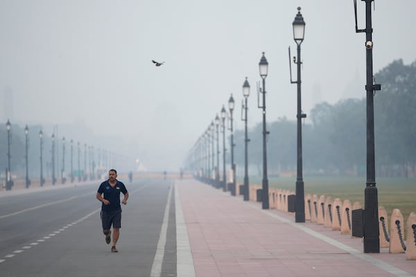 FILE - A man jogs in the early morning smog in New Delhi, Nov. 1, 2024. (AP Photo/Manish Swarup, File)