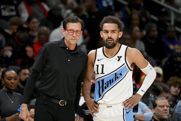 Atlanta Hawks head coach Quin Snyder confers with Atlanta Hawks guard Trae Young (11) during the first half in an NBA basketball game at State Farm Arena, Friday, December 7, 2024, in Atlanta. Atlanta Hawks won 134 - 132 over Los Angeles Lakers. (Hyosub Shin / AJC)