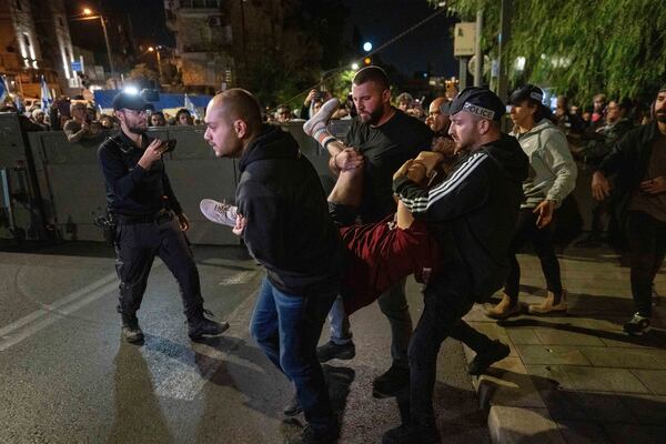 Police disperse people protesting against Prime Minister Benjamin Netanyahu's near his residence in Jerusalem after he has dismissed his defense minister Yoav Gallant in a surprise announcement, Tuesday, Nov. 5, 2024. (AP Photo/Ohad Zwigenberg)