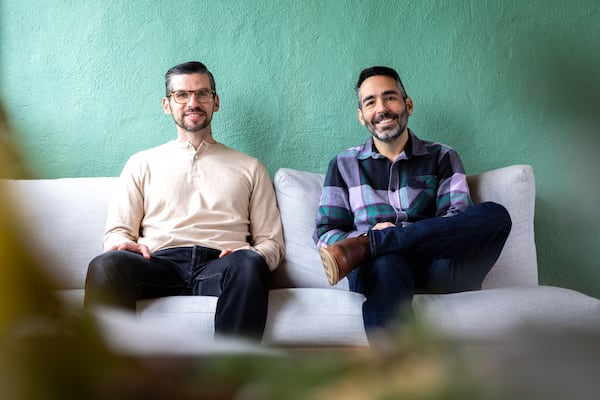 Developers Benjamin McLoughlin (left) and Michael Garber of Canvas Companies sit on the rooftop of Otto’s Apartment Hotel in Atlanta on Monday, Dec. 9, 2024. The renovated apartment complex was formerly the Highland Inn and Ballroom. (Arvin Temkar/AJC)