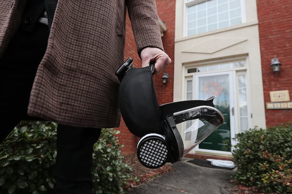 Ryan Proffitt, a 39-year-old language arts teacher at Lanier High School in Gwinnett suffering from long-term effects of COVID-19, carries a N-95 battery powered respirator he wears in the classroom and out in public while leaving his home on Feb.1, 2021, in Sugar Hill.  (Curtis Compton / Curtis.Compton@ajc.com)