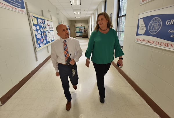 School Business Manager Brian Baron and Principal Audrey Sofianos talk as they walk down the hall at Morningside Elementary School on Friday, September 28, 2018. HYOSUB SHIN / HSHIN@AJC.COM