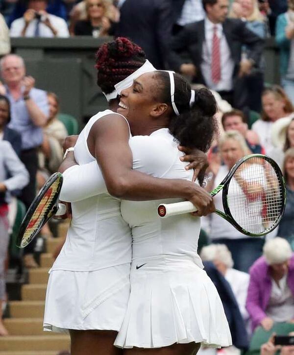 Serena Williams, right, and Venus Williams embrace after winning the women's doubles final against Yaroslava Shvedova of Kazahkstan and Timea Babos of Hungary on day 13 of the Wimbledon Tennis Championships in London on July 9. AP Photo/Tim Ireland