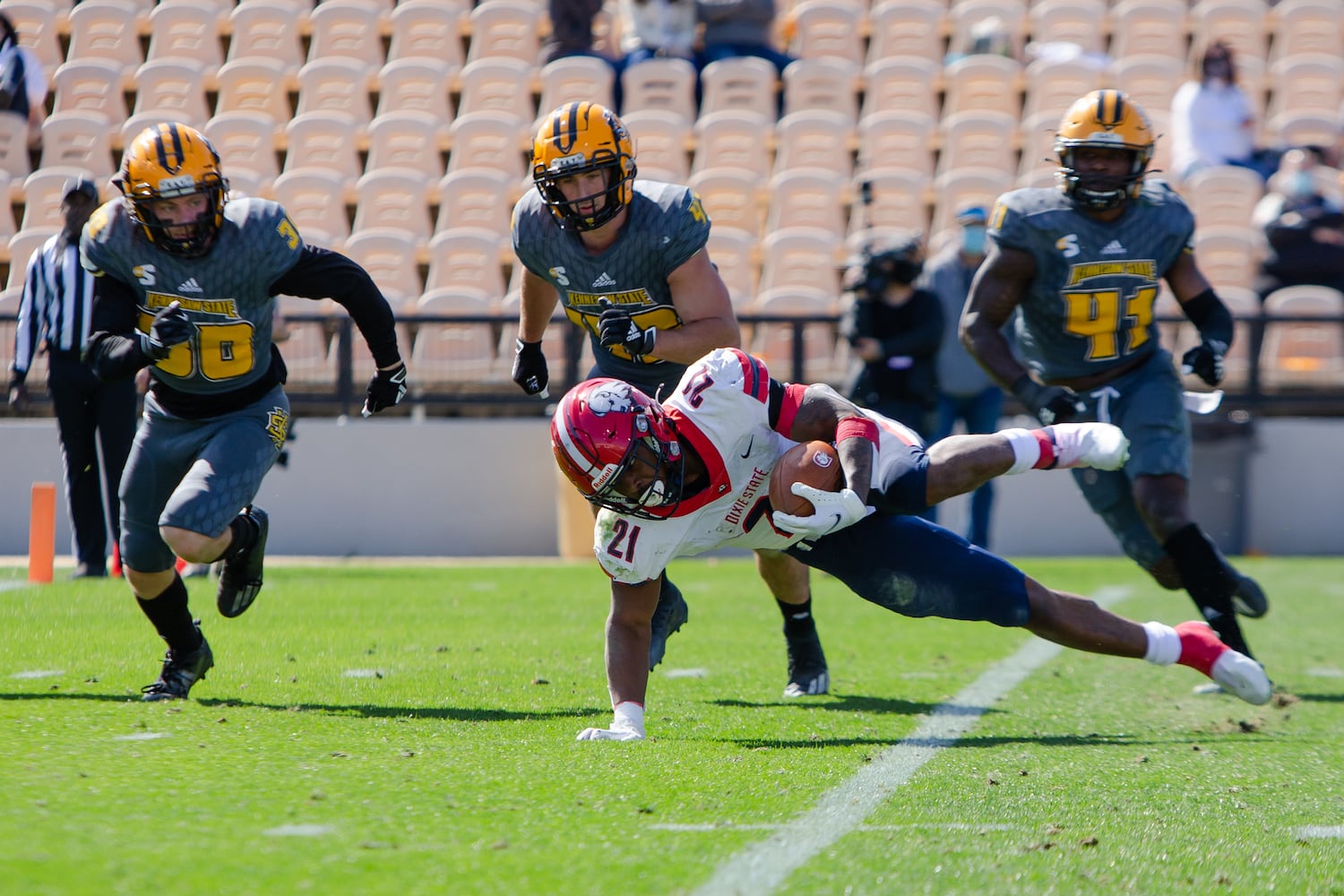 Quali Conley, freshman running back for Dixie State, trips up while running the ball. CHRISTINA MATACOTTA FOR THE ATLANTA JOURNAL-CONSTITUTION.